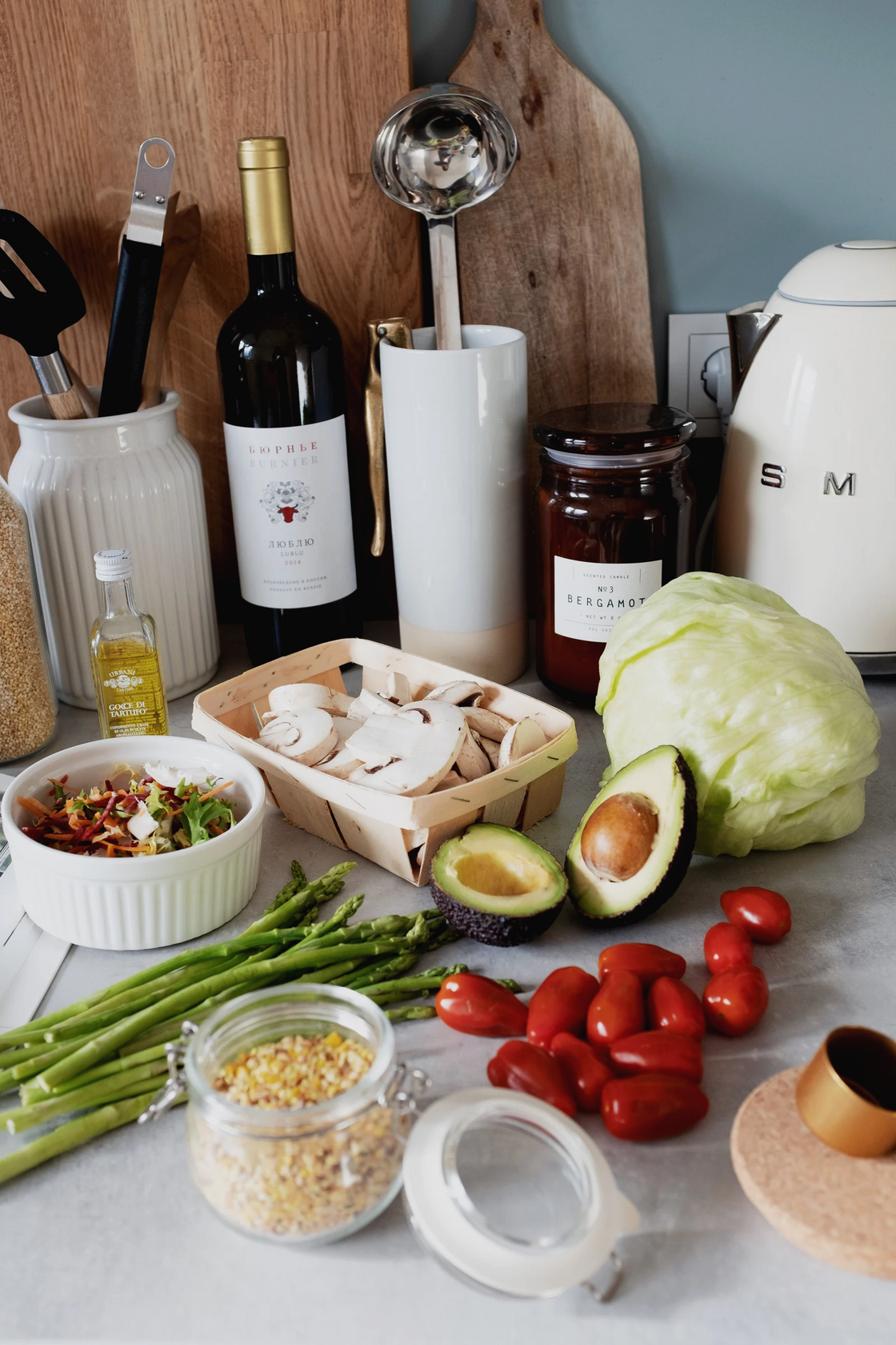 sliced avocado, cabbage, mushrooms, oil, beans, and other ingredients laid out on a surface